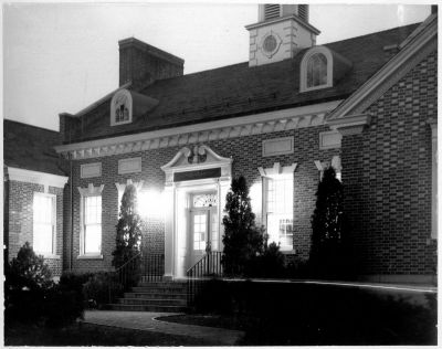 Front Facade
The warmth of the library's brick construction and its colonial architectural details stand out in this night-lit view, circa 1940.
